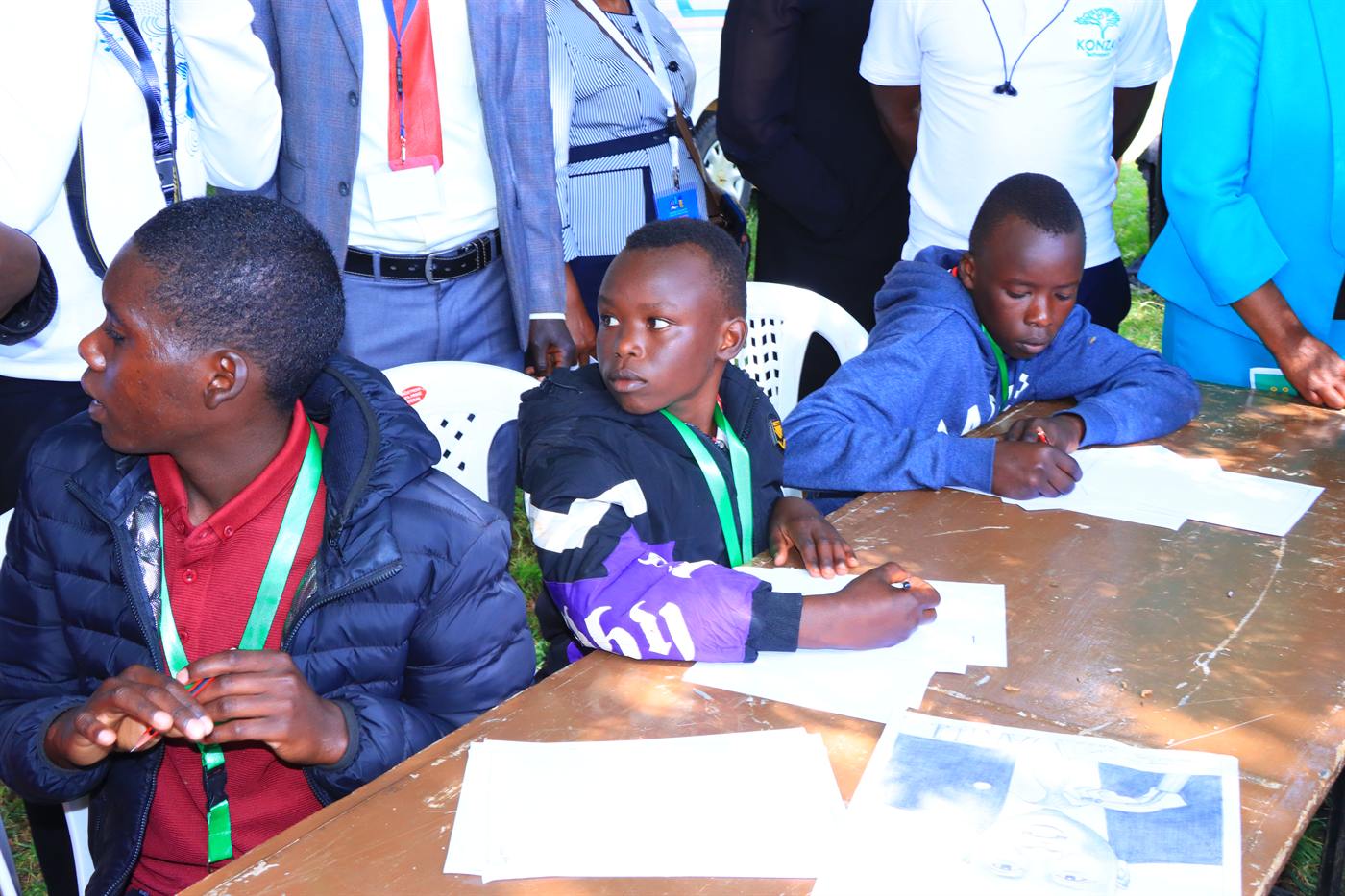 Young participants seated at an outdoor table