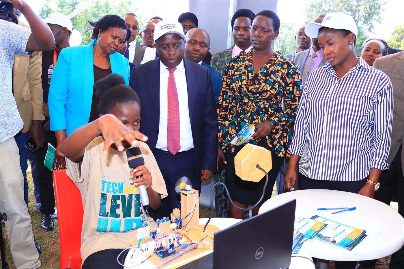 A young exhibitor demonstrating an innovation to festival guests