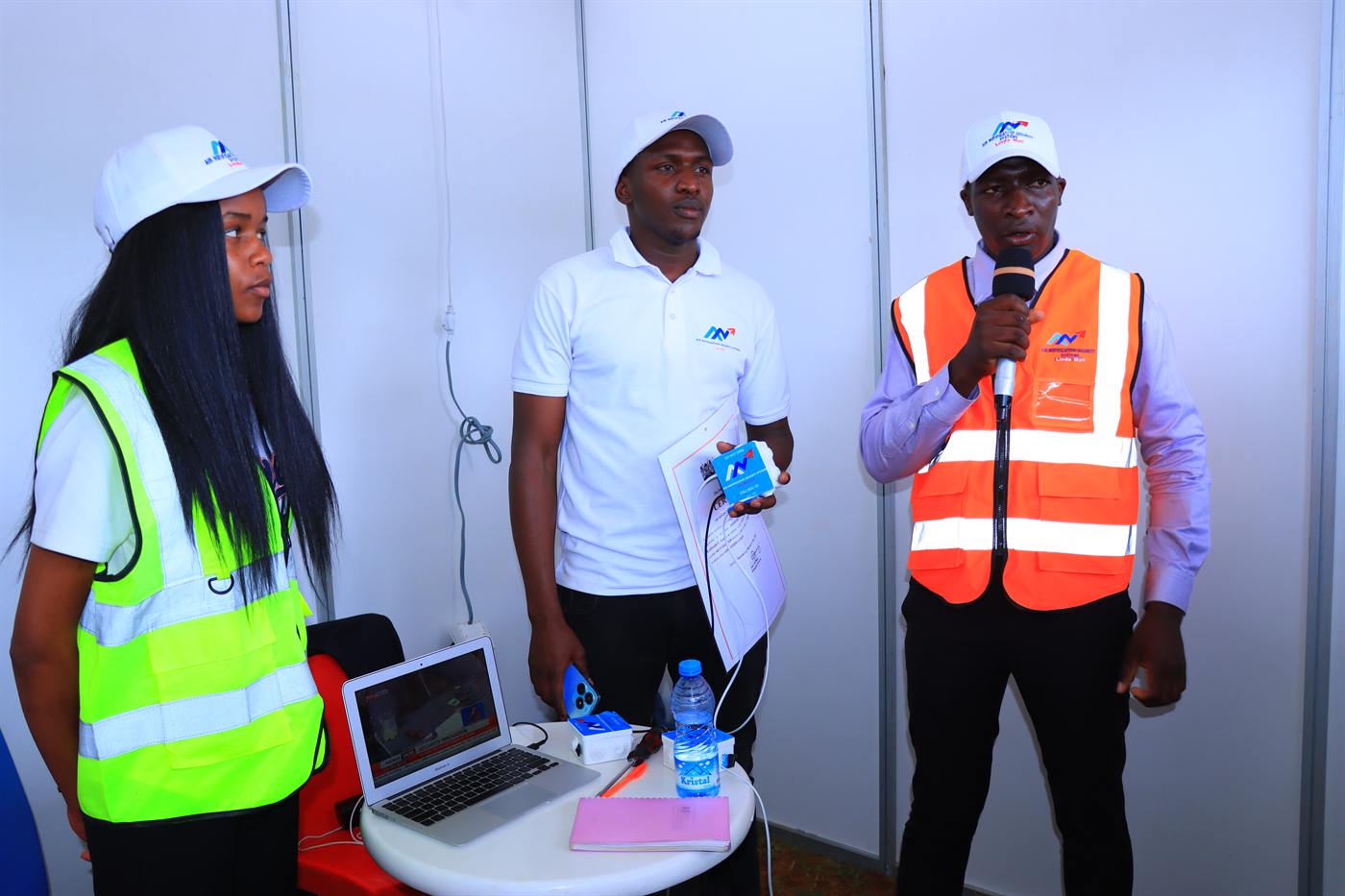 A team presenting a project beside a laptop