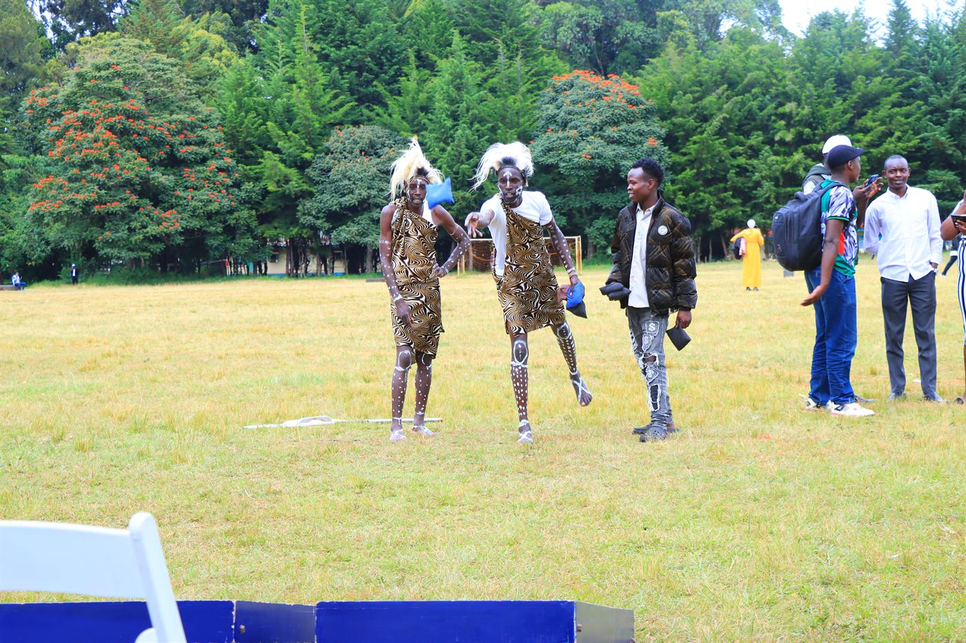 Dancers in traditional attire performing on the festival field
