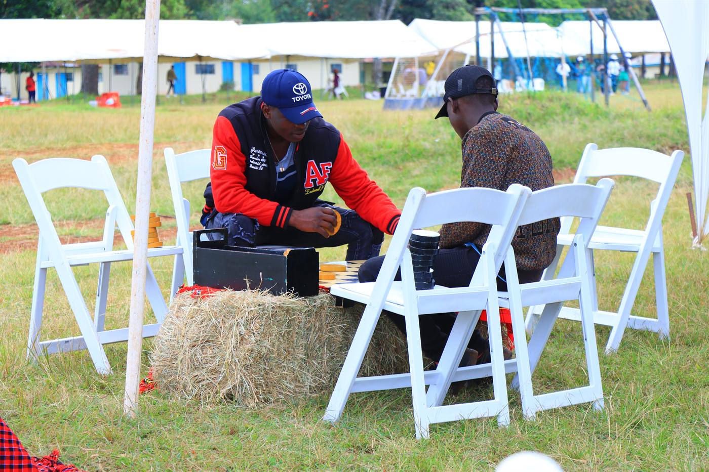 Two participants seated outdoors between festival activities