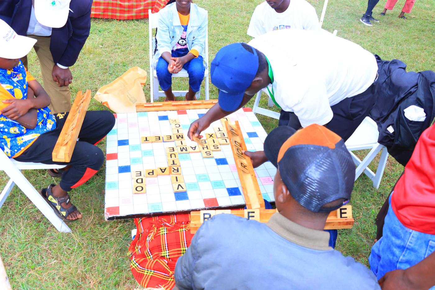 Young people playing scrabble outdoors at the festival