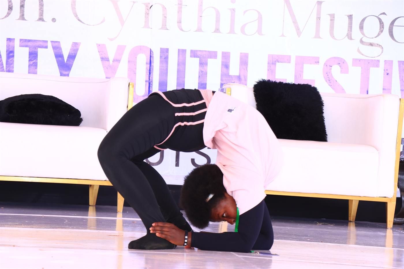 A dancer in a deep backbend on the festival stage